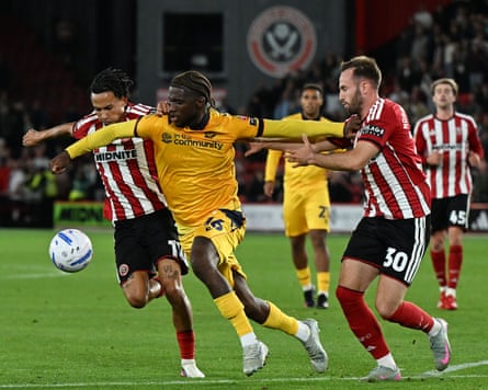 Bolton’s Samuel Iling-Junior attempts to go past Romelle Donovan and Rhys Norrington-Davies of Sheffield United