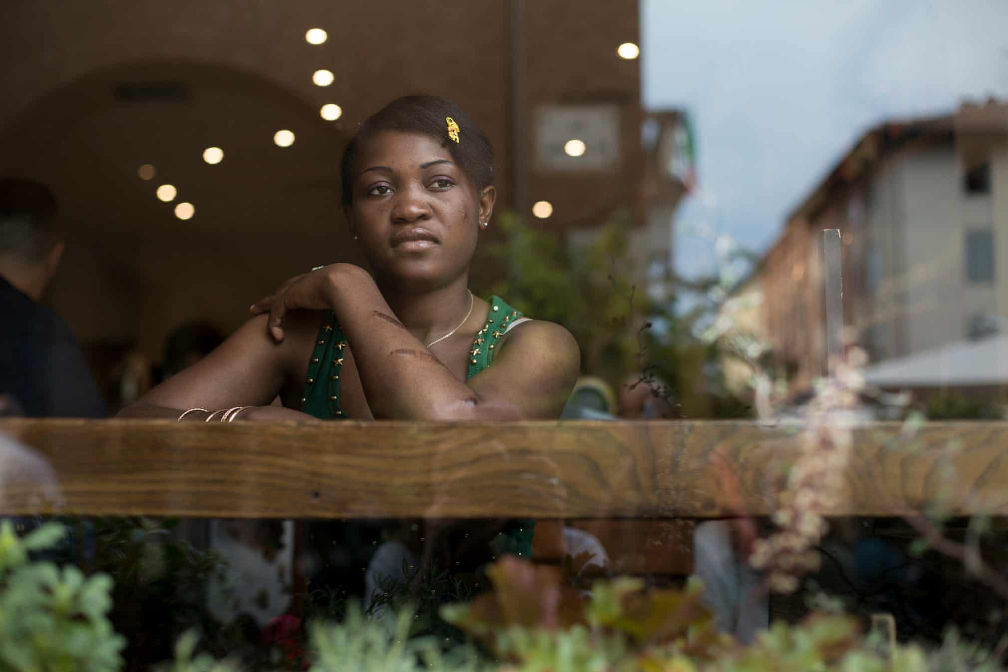 Precious, a 20-year-old Nigerian woman, in a bar in Asti, near Turin.