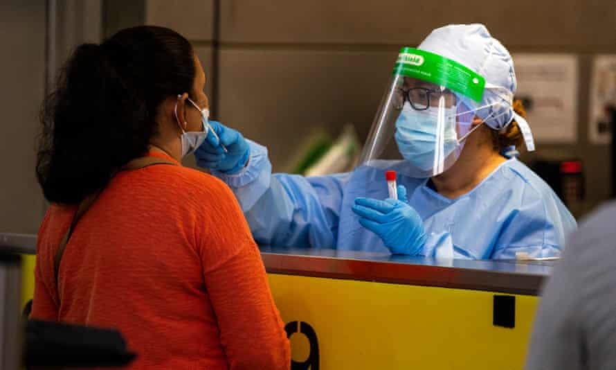 A healthcare worker tests a person for Covid-19 in Los Angeles, California, on 4 February. 