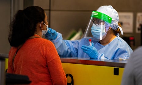 A healthcare worker tests a person for Covid-19 in Los Angeles, California, on 4 February. 