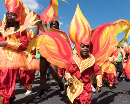 three children dressed in petal shapes painted like flames