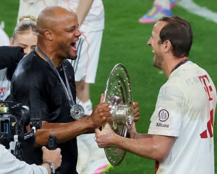 Kane celebrates with Vincent Kompany, the Bayern manager