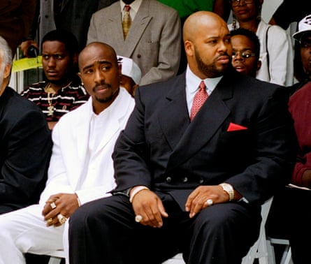 Tupac Shakur and Marion ‘Suge’ Knight sitting in suits