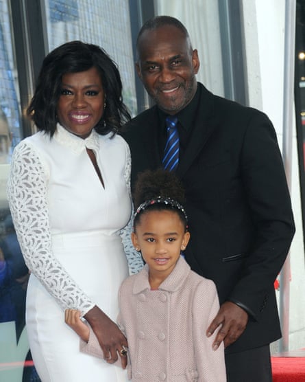 With her husband, actor Julius Tennon, and daughter.