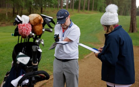 Tony Lloyd, from the Shropshire golf club, checks his score with an official