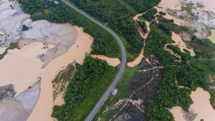 Aerial image of a road cutting through an area deforested by illegal gold mining in the Madre de Dios province of Peru.