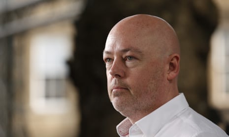 Portrait of John Boyne looking to left of camera, looking serious