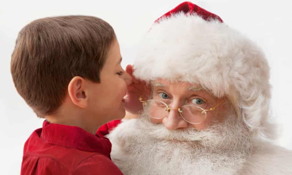 Boy telling Santa what he wants for Christmas