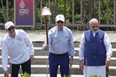 Anthony Albanese, decked in the full uniform, Joe Biden and Narendra Modi at a tree planting at the Taman Hutan Raya Ngurah Rai mangrove forest, on the sidelines of the G20.