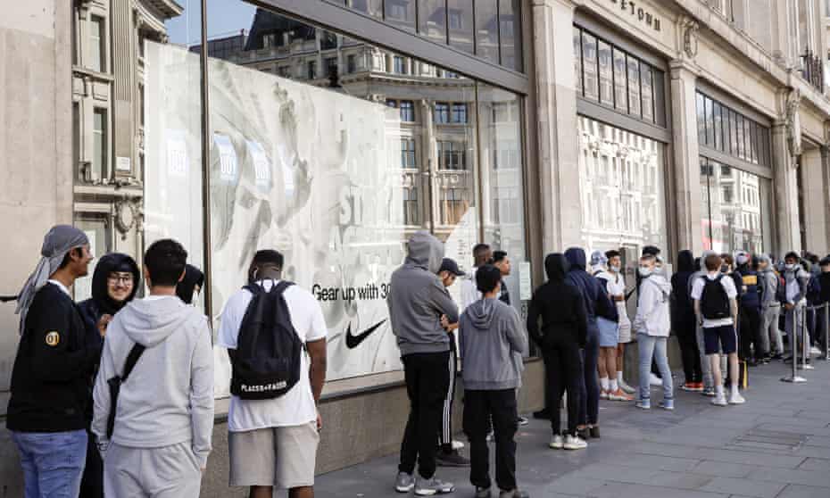 People queue to enter the Niketown shop in London, Monday