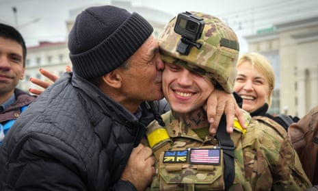 A Kherson resident kisses a Ukrainian soldier on 13 November, after the city’s liberation.