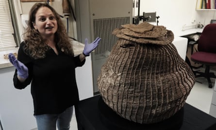 Archaeologists display the huge intact basket, dating to the pre-pottery Neolithic period, that was unearthed in Murabaat Cave in the Judean Desert.