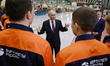 Vladimir Putin talks to workers at an aviation factory in the eastern Siberian city of Ulan-Ude in March 2023.