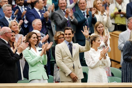 Roger Federer waves from the Royal Box.