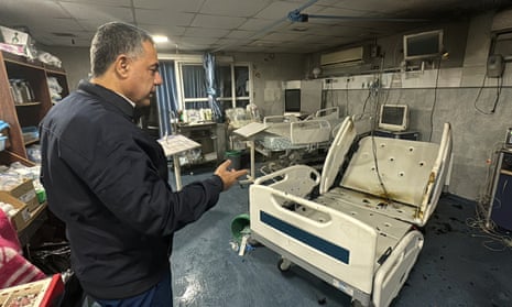 Abu Safiya, director of Kamal Adwan hospital, shows the damage from an Israeli attack inside the hospital in Beit Lahiya.
