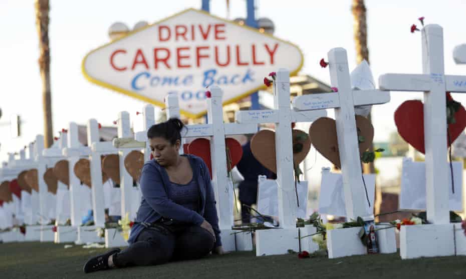 Cece Navarrette sits near a display of crosses for those killed during the mass shooting in Las Vegas in 2017.