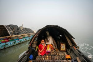 Guwahati, IndiaA young girl sits with her grandmother on a boat in the river Brahmaputra as she waits for her father’s return from the fish market