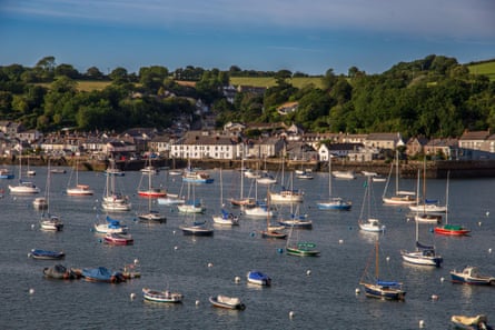 Falmouth harbour, Cornwall UK with boats and distant houses on a sunny day with clear blue sky