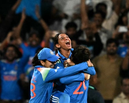 Harmanpreet Kaur, India cricket captain, jumps into the arms of one teammate while being hugged by another in celebration of her team winning the Women’s ODI World Cup.