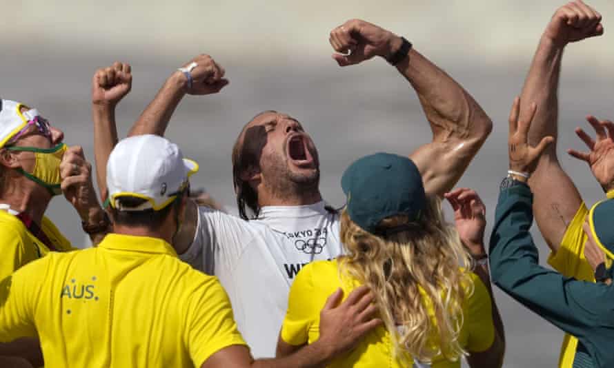 Australia’s Owen Wright celebrates winning the bronze medal heat in the men’s surfing competition.