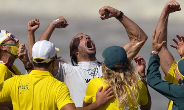 Australia’s Owen Wright celebrates winning the bronze medal heat in the men’s surfing competition. 