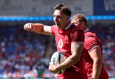 Josh Adams celebrates scoring the fourth try for Wales