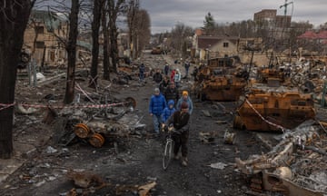 Yearender 2022 - Ukraine War<br>epa10364901 Residents walk past destroyed Russian military machinery on the street, in Bucha, the town which was retaken by the Ukrainian army, northwest of Kyiv, Ukraine, 06 April 2022. EPA/ROMAN PILIPEY