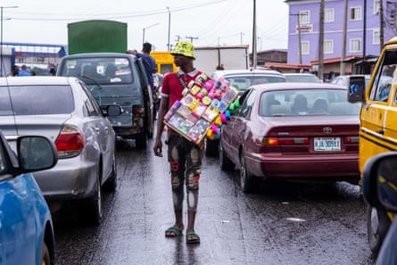 Street hawkers sell their goods amid Lagos traffic jams
