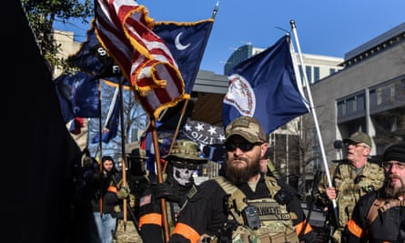 An armed militia gathers in front of the Virginia state capitol building in Richmond, Virginia, on 20 January.