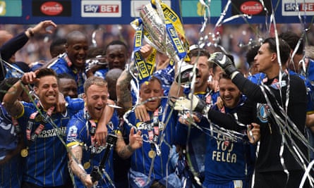 AFC Wimbledon players celebrate winning promotion to League One