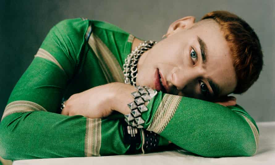 Olly wears top: Bianca Saunders. Earrings: Shaun Leane. Leather choker: R&M Leathers. Flower necklace: Hatton Labs. Chain necklace and bracelet: Gråsilver.