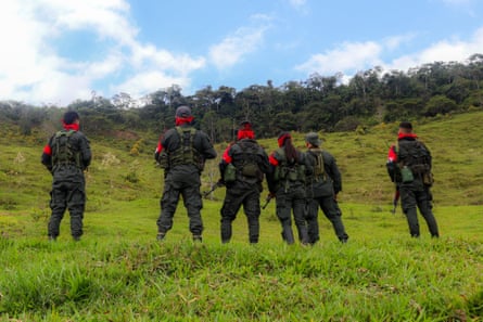 National Liberation Army (ELN) rebels stand with guns.