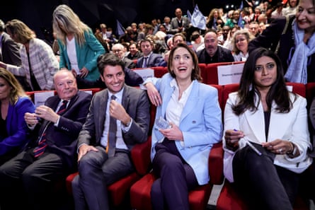 The French prime minister Gabriel Attal, second left, and Renaissance party European candidate Valerie Hayer, third left, sitting in re chairs laughing and smiling.
