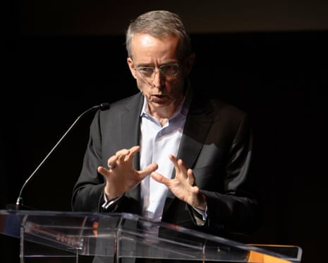 A man gestures as he speaks.