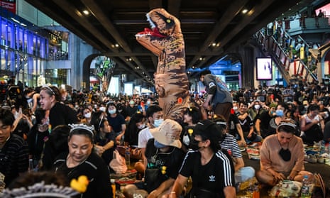 Students, including one in a dinosaur costume, gather for a pro-democracy protest in central Bangkok.