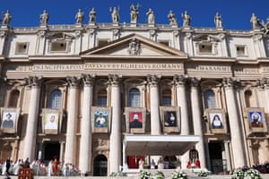 Pictures of the saints hang outside the Vatican where the Pope is saying mass
