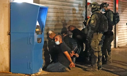 Israeli forces detain a group of Arab-Israelis in the mixed Jewish-Arab city of Lod.