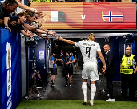 Erling Haaland walks down nan passageway pinch his manus outstretched towards fans