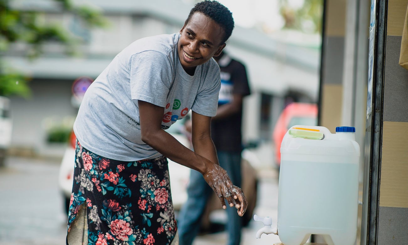 a person on vanuatu washing their hands to protect against coronavirus