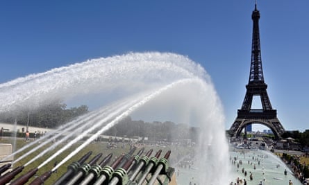 People cool down in the fountains near the Eiffel Tower in Paris during the June heatwave.