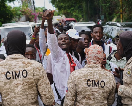 Police officers block medical students from advancing during a protest demanding the reopening of the General Hospital in Port-au-Prince, Haiti, last week.