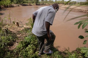 Joseph Oyamo on the eroded banks of a river in Kisumu county.
