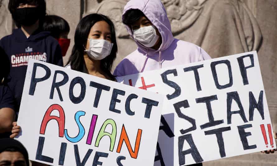 People hold signs at a Stop Asian Hate rally in Chicago in March.
