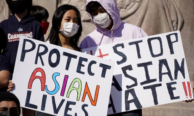 People hold signs as they attend a rally to support Stop Asian Hate in Chicago.