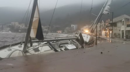 A boat leans towards a wall during storm Ianos in Agia Efimia, Kefalonia, Greece.