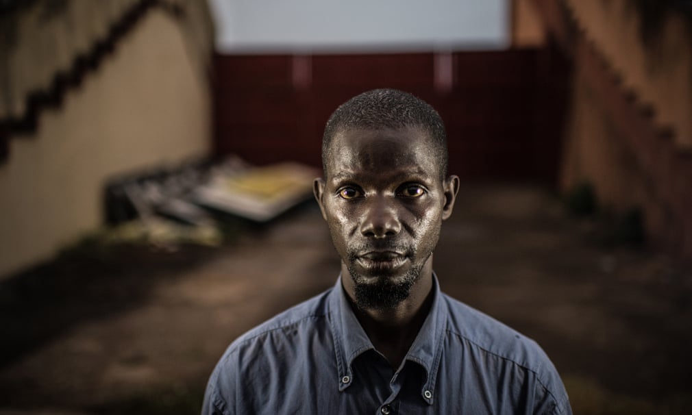 Thierno Maadjou Sow was photographed at the gates where he was beaten unconscious and had his leg broken.