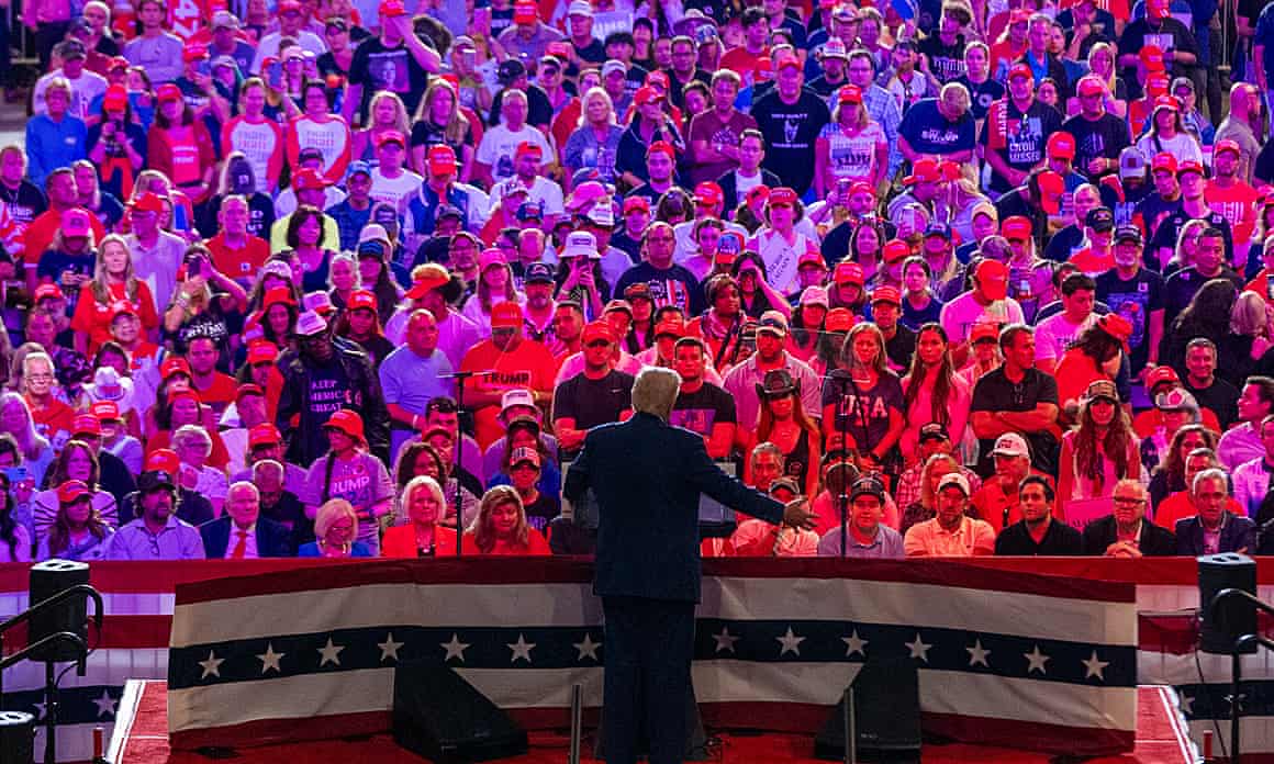 Donald Trump standing on a stage talking to crowds.