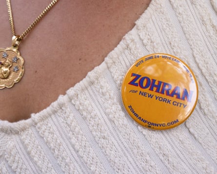 A supporter of Zohran Mamdani wearing a yellow badge saying ‘Zohran for New York City’ at a campaign event in New York in June.