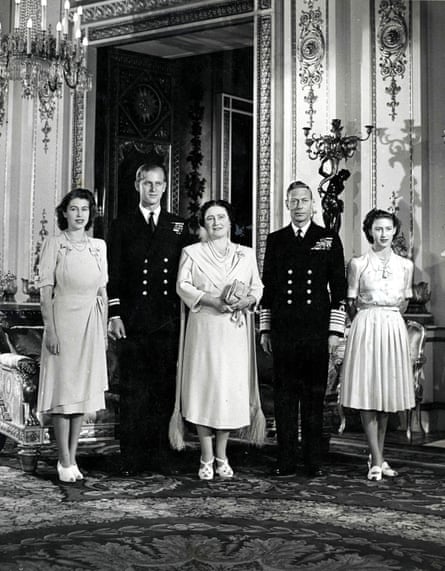 King George VI and Queen Elizabeth pose for a family portrait with Princess Elizabeth, her fiancé Philip Mountbatten, and Princess Margaret at Buckingham Palace in October 1947.