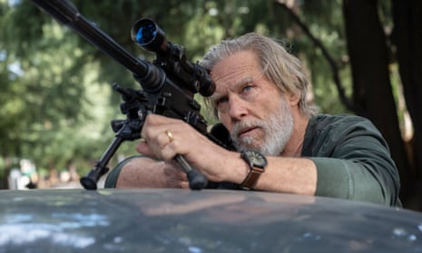 Jeff Bridges as Dan Chase, looking down the barrel of a telescopic rifle.